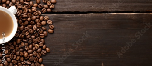 A ceramic mug brimming with aromatic coffee sits amidst a backdrop of rich dark roasted coffee beans