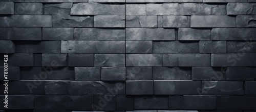 Dark wall covered with numerous black paper squares in a grid pattern