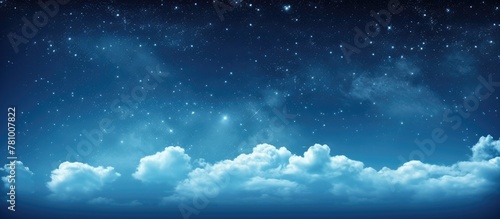 Fototapeta Naklejka Na Ścianę i Meble -  Starry night sky filled with twinkling stars and fluffy clouds drifting across
