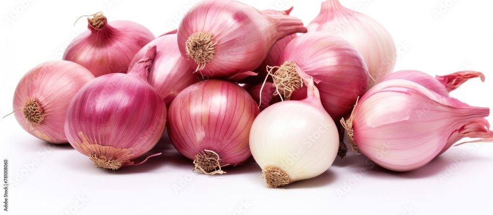 A close-up view of multiple onions stacked on a plain white surface A close-up view of multiple onions stacked on a plain white surface