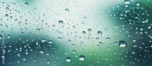 Water droplets from rain covering the surface of a window  creating a blurred effect