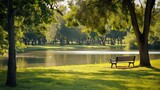 Serene park scene with bench overlooking calm lake surrounded by lush green trees bathed in warm sunlight