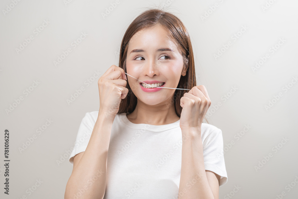 Flossing teeth, dental care hygiene concept, asian young woman flossing teeth with dental floss, smile happy with perfect white teeth, using tooth floss cleaning, healthy teeth isolated on background. Flossing teeth, dental care hygiene concept, asian young woman flossing teeth with dental floss, smile happy with perfect white teeth, using tooth floss cleaning, healthy teeth isolated on background.