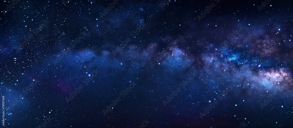 A serene night scene with a dark blue sky filled with numerous stars and a few small white dots twinkling in the distance