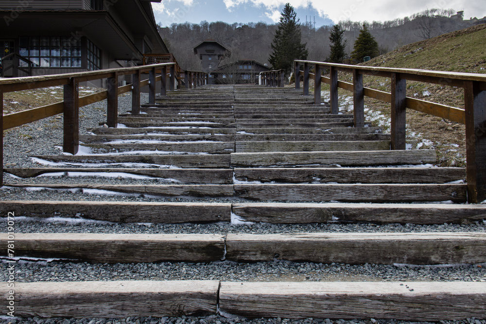 Obraz premium wooden stairs with stones and wooden railings