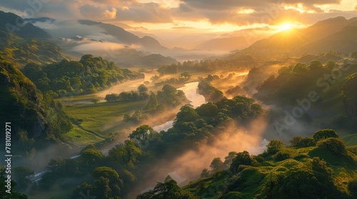 A mist-covered river valley at sunrise, with verdant hillsides bathed in soft golden light. photo