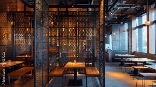 The use of perforated metal as a partition in a restaurant creates a sense of airiness and light with the tered illumination from the hidden lights adding a theatrical element to the . photo