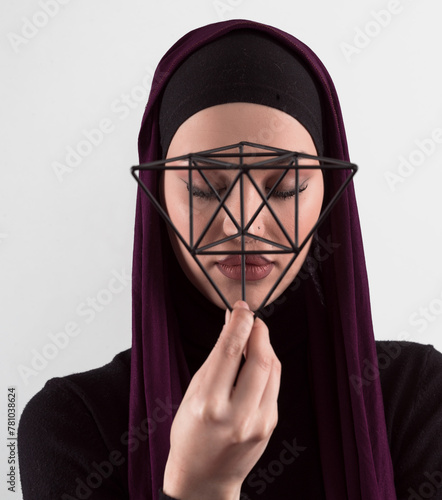 Muslim woman wearing modern stylish wear and hijab isolated on grey background. Diverse people model hijab fashion concept. Face recognition and biometric data identify face science. © .shock