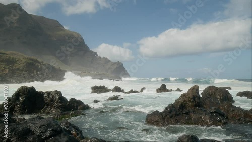 Slowmotion ocean waves crushing on sharp volcanic rocks near Punta Negra, Buenavista del Norte, Tenerife, Canary Islands in spring photo
