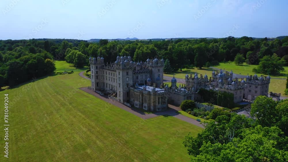 Aerial View of Famous Scottish Castle and Garden in Scottish Borders, Famous Landmark in Kelso, Scotland, United Kingdom. Aerial View of Famous Scottish Castle and Garden in Scottish Borders, Famous Landmark in Kelso, Scotland, United Kingdom.