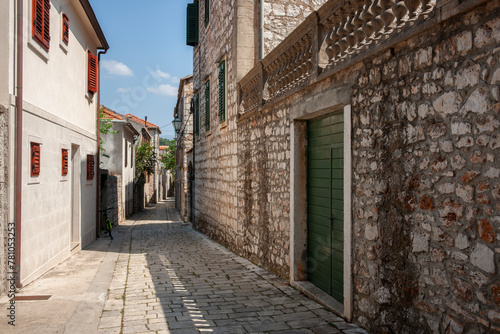 Lane leading between typical European buildings