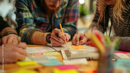 A creative team collaborating on a project, surrounded by sketches and sticky notes.