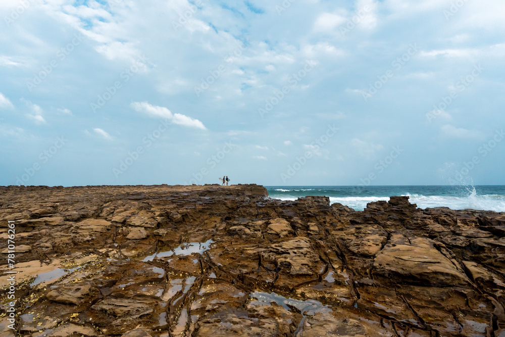 Surfers at Avoca beach rock platform, NSW AUSTRALIA Surfers at Avoca beach rock platform, NSW AUSTRALIA