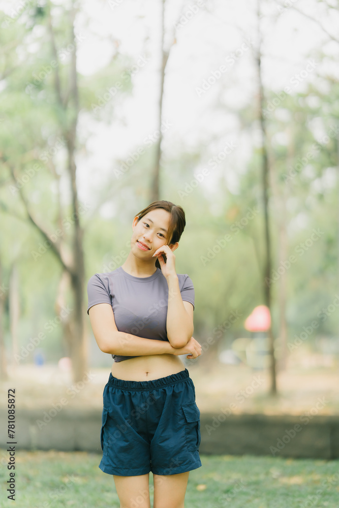Asian woman stretching and warming up before going for a run at the park. Yoga, health care, weight loss exercise. Asian woman stretching and warming up before going for a run at the park. Yoga, health care, weight loss exercise.
