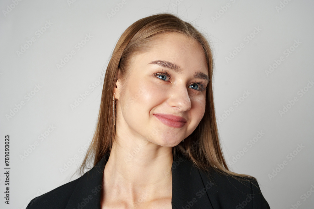 Young Woman in Black Jacket Posing to Camera against gray background Young Woman in Black Jacket Posing to Camera against gray background