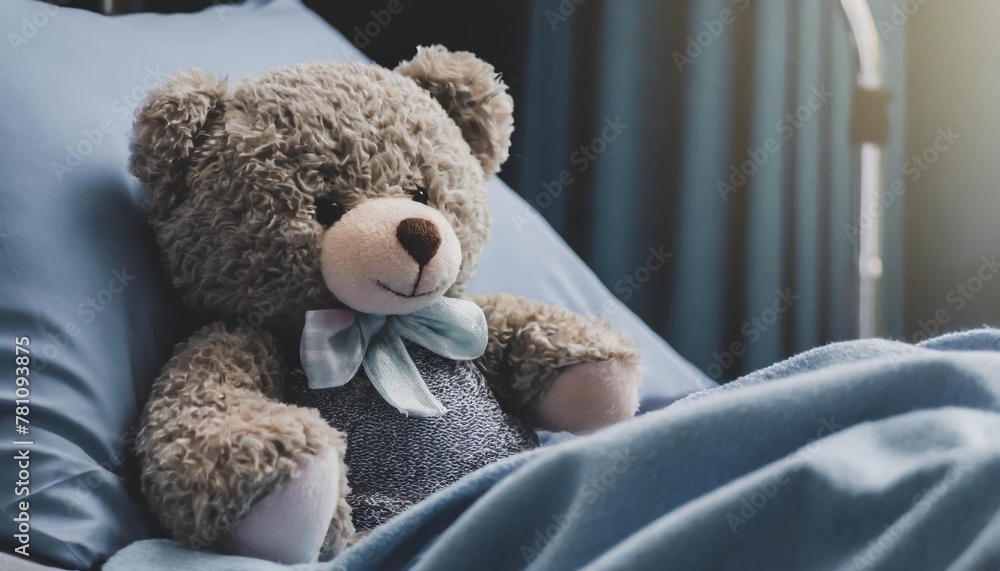 banner with cute teddybear toy on patient bed at hospital health center or hospital room for young patient healthcare and childhood concept