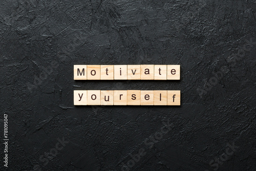 motivate yourself word written on wood block. motivate yourself text on cement table for your desing, concept