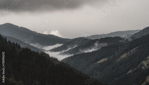 landscape of misty mountains view of coniferous forest layers of mountain and haze in the hills at distance beautiful cloudy sky tourism and travelling © Robert