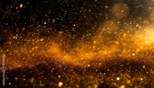 particules scintillantes et brillantes volant sur fond sombre noir lumiere orangee etoile paillette doree et flou cosmos univers espace fond pour banniere conception et creation graphique © Robert
