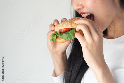 Asian woman smiling when eat fastfood isolated on whit background.