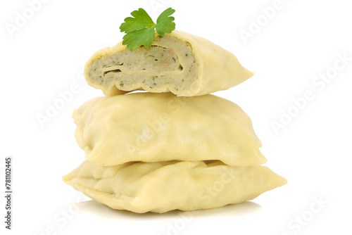 Origin Bavarian or German pasta squares with filling of pork meal and vegetables isolated on white