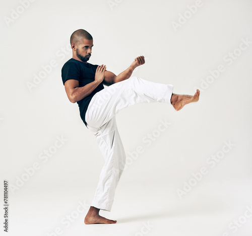 Man, studio and martial arts for training practice, action and karate exercise on white background. Black male person, mockup space and strong for combat, fight and position of attack in kung fu © peopleimages.com