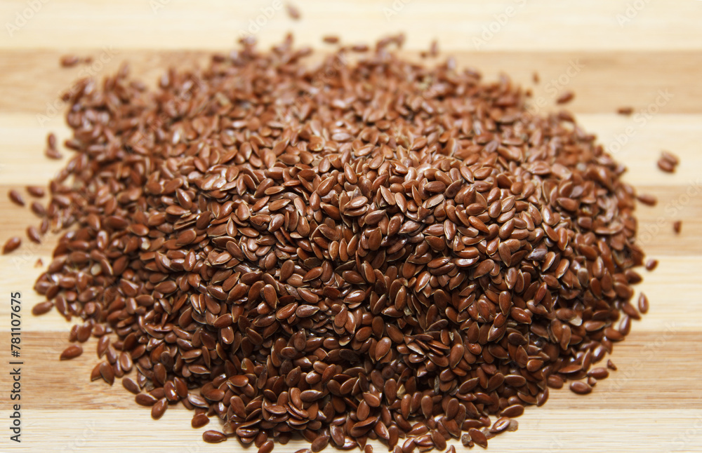 Linen fresh raw seeds lie on a wooden surface. Top view. Linen fresh raw seeds lie on a wooden surface. Top view.