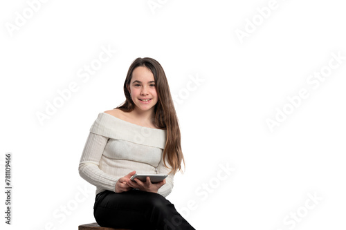 A girl is sitting on a bench and holding a tablet