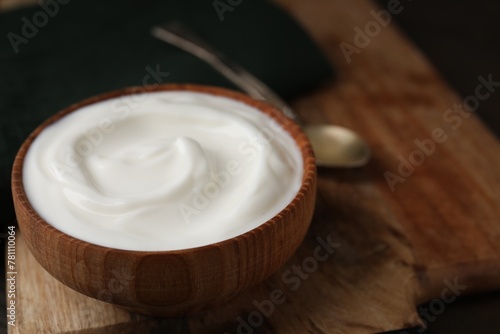 Delicious natural yogurt in bowl on table, closeup. Space for text