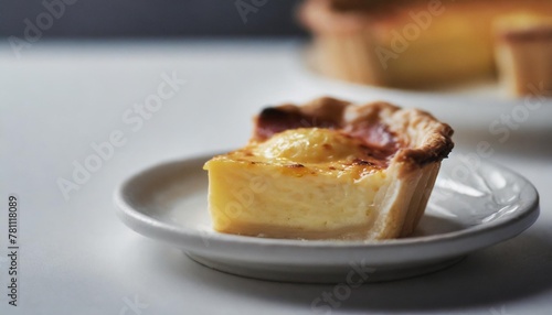 quiche lorraine pie with beechwood smoked bacon creamy cheddar cheese and free range egg in shortcrust pastry on a white plate and modern white background banner with copy space photo