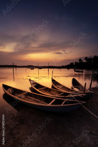 Traditional boats at O Loan lagoon in sunset, Phu Yen province, Vietnam © CravenA