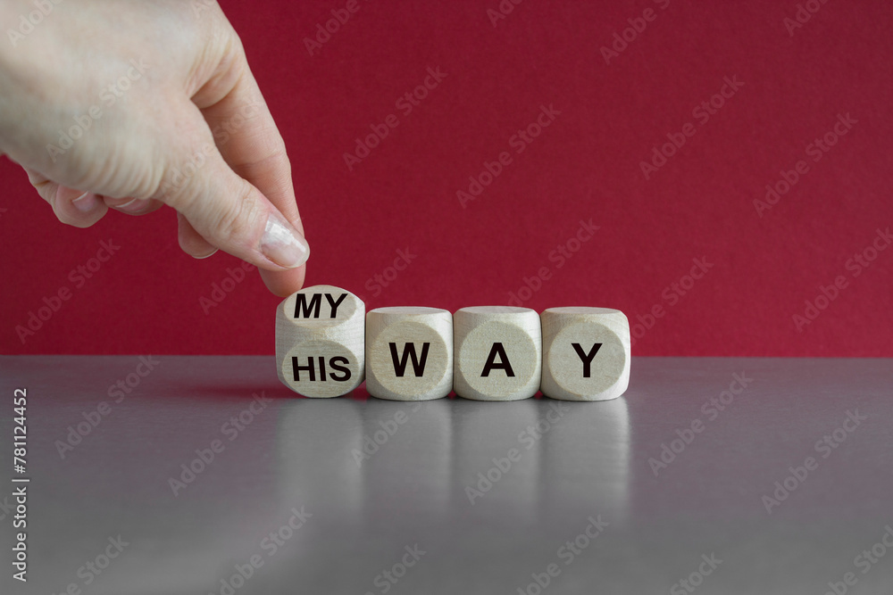 Turned a cube and changes the expression his way to my way. Businessman hand. Beautiful grey table, red background. Business concept