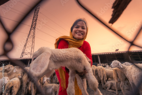 Vietnamese woman with lamb on a countryside, a sheep farm in the steppe zone in Ninh Thuan Province, Vietnam. photo