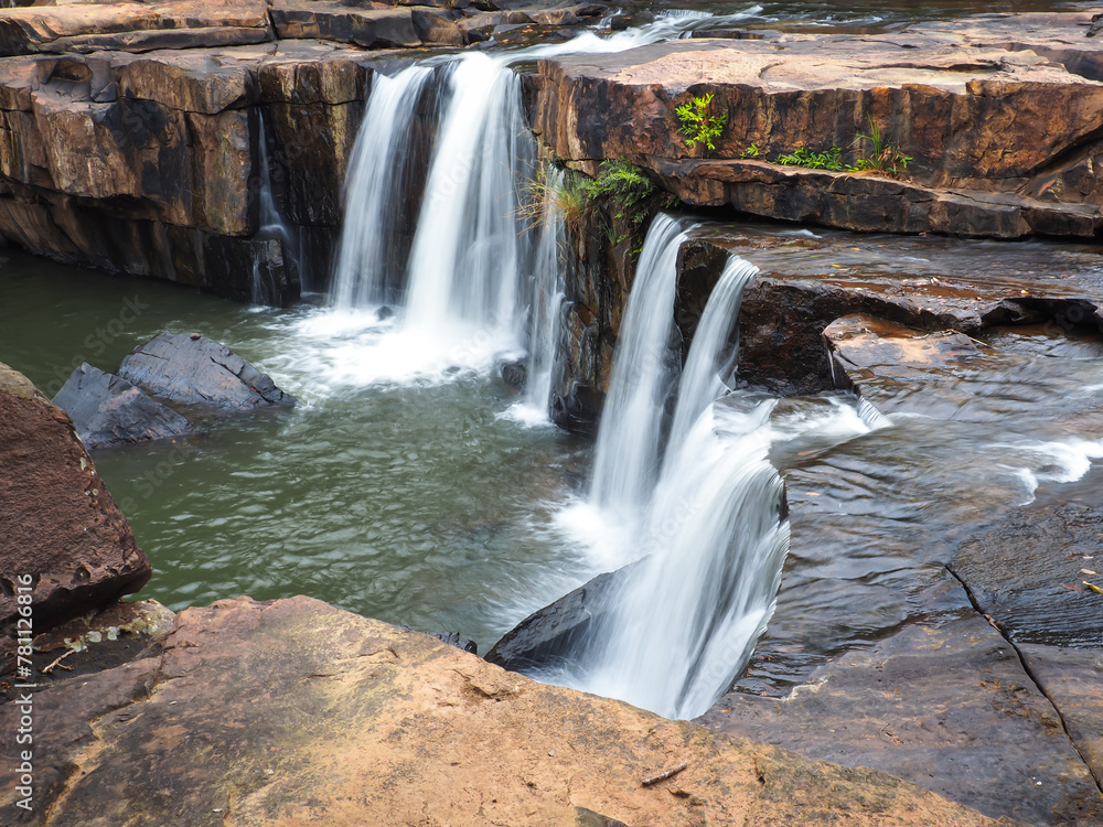 Cool waterfall flowing in the deep forest, shady atmosphere. Cool waterfall flowing in the deep forest, shady atmosphere.