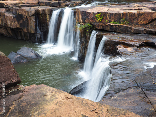 Cool waterfall flowing in the deep forest, shady atmosphere.