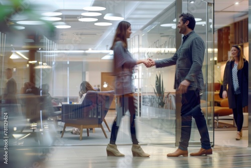 A young business man shaking hands with an attractive woman in the office photo