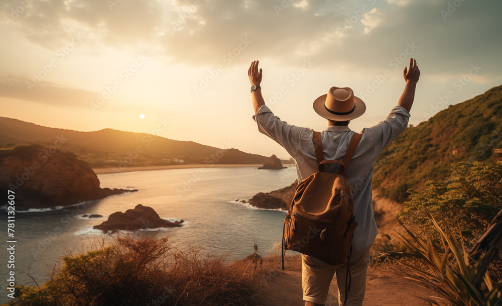 Fototapeta premium Young guy with backpack and cap reveling in seaside scenery