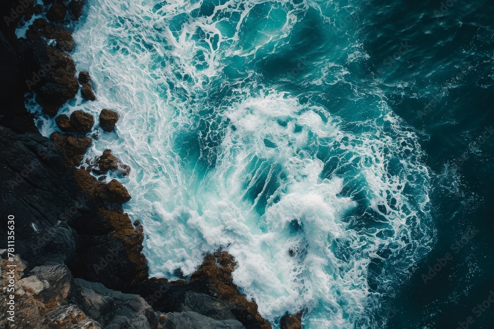 An aerial perspective capturing the powerful interaction between the ocean waves and rocky shoreline, A spectacular overhead view of foamy sea waves smashing against rocks, AI Generated