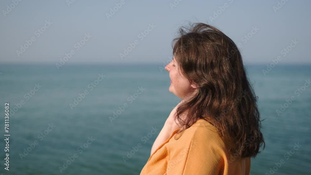 Northern woman with pale skin enjoys warm sunshine in maritime country. Young woman exposes face to sun rays and closes eyes in pleasure. Low vitamin D levels, exposure to ultraviolet radiation. Northern woman with pale skin enjoys warm sunshine in maritime country. Young woman exposes face to sun rays and closes eyes in pleasure. Low vitamin D levels, exposure to ultraviolet radiation.