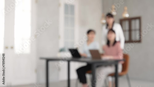 Blurred concept of group of women wearing casual wear working in the office. Corporate employee. Human resources. photo