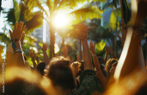 people dancing at a concert with their hands up, view from the back photo