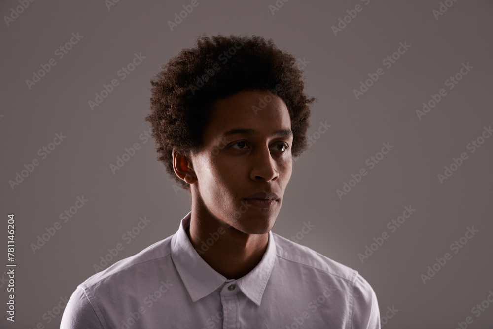 Obraz premium Serious, thinking and man in studio with ideas for project and dark background with mock up space. Creative, person and planning a decision or choice in fashion with college student on backdrop