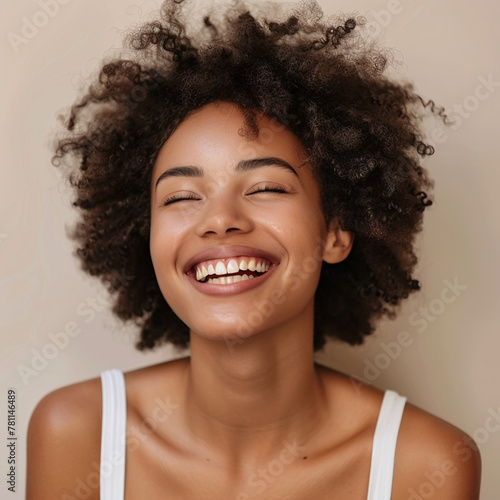Portrait of a smiling African American woman with curly hair posing happily