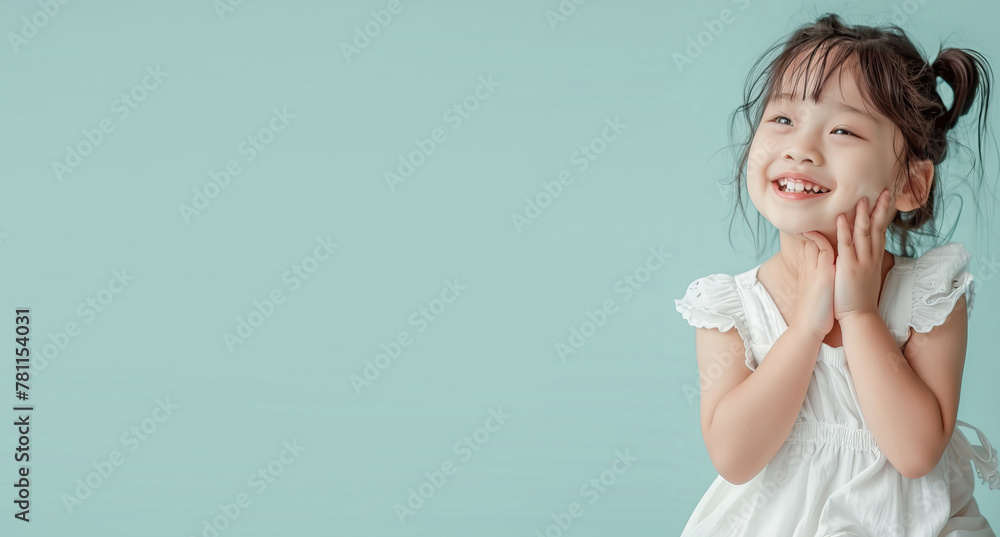 Little girl on a mint background smiling
Little girl on a mint background smiling