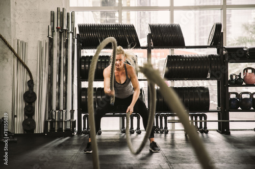 Beautiful young woman training at the gym photo