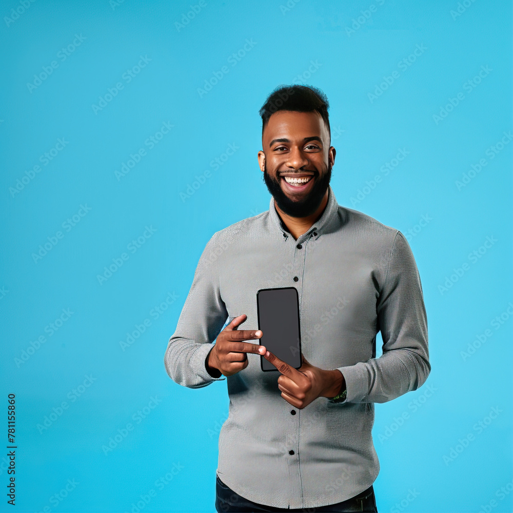 Smiling man on a blue background holding a smartphone in his hands
Smiling man on a blue background holding a smartphone in his hands