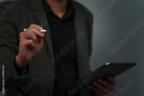 businessman hand using pen writing on empty virtual screen with digital tablet
