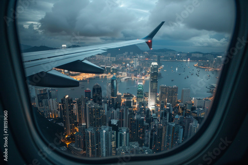 Cityscape view with the flight wing from an airplane through window seat