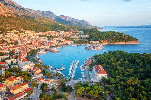 Aerial view of the harbor and old town of Makarska, Dalmatia, Croatia. Summer landscape with yachts, sea, architecture and rocks, famous tourist destination at Adriatic seacoast, travel background
