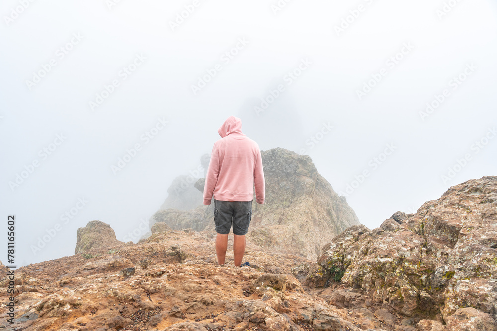 Naklejka premium A tourist visiting the very cloudy Pico de las Nieves in Gran Canaria, Canary Islands. Spain